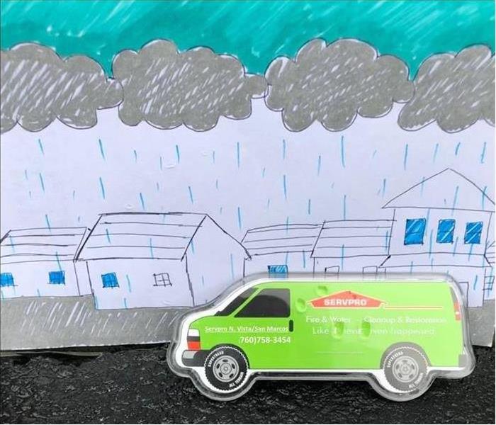 SERVPRO van driving in pencil drawn rain.